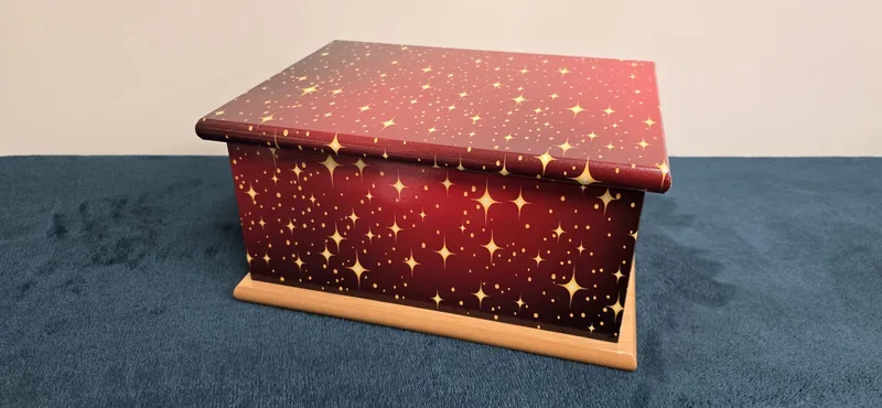 A casket in deep red, scattered with stars