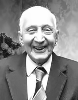 Will Case — a black and white portrait of an elderly man in a jacket and tie, smiling broadly
